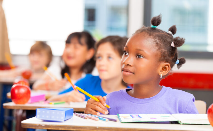 Happy children in a multi ethnic elementary classroom