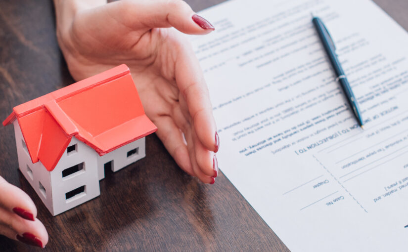 Cropped view of female hands near house model, paper with bankru