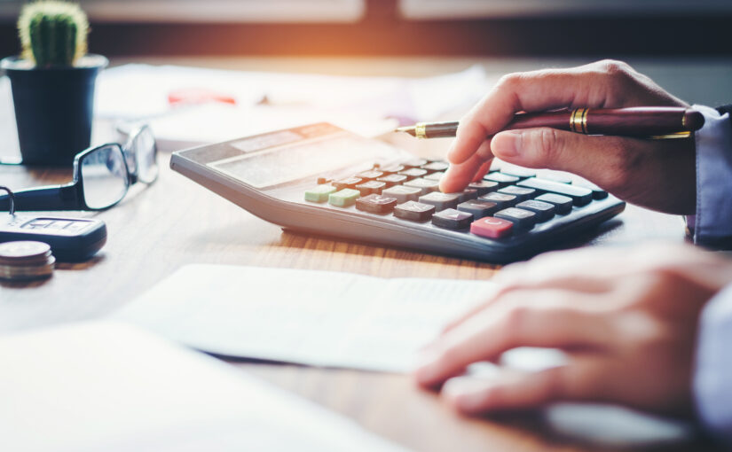 Businessman's hands with calculator and cost at the office